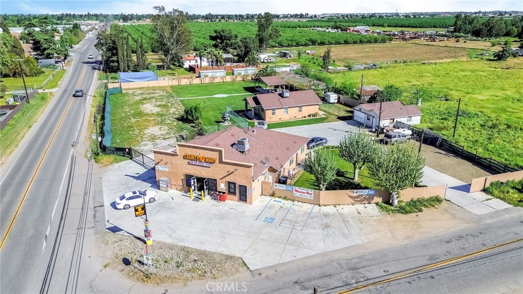 24110 Ave 14 Madera, CA 93637 - Photo 3 of 43 an aerial view of a house with a garden and lake view