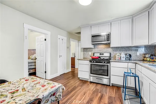 a kitchen with stainless steel appliances a stove a sink dishwasher and a refrigerator