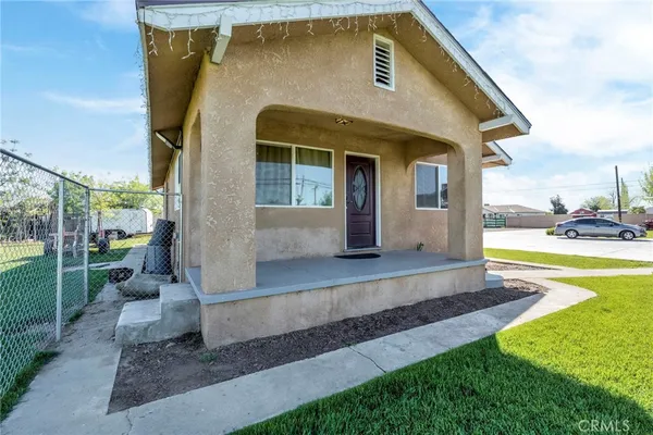 a front view of a house with swimming pool having outdoor seating