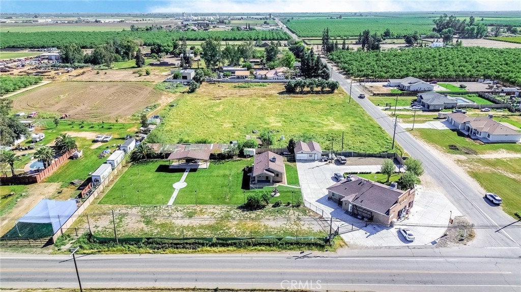 24110 Ave 14 Madera, CA 93637 - Photo 5 of 43 an aerial view of a swimming pool with a yard and lake view