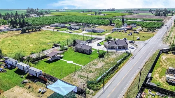 an aerial view of a house with outdoor space swimming pool patio and lake view
