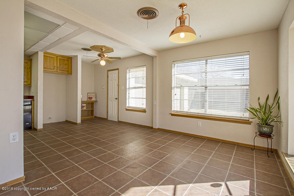 4818 Camp Lane Amarillo, TX 79110 - Photo 13 of 32 an empty room with windows and ceiling fan