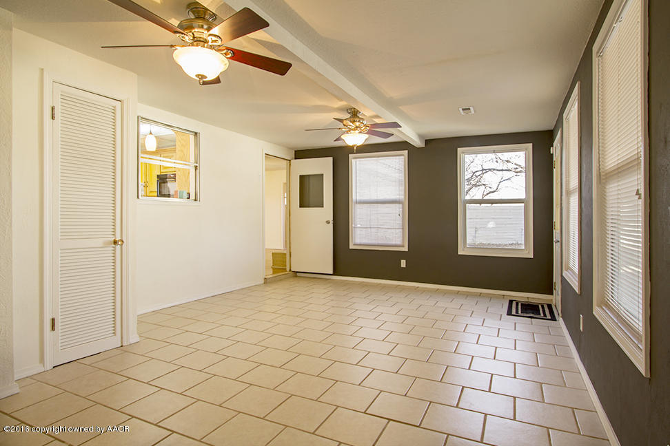 4818 Camp Lane Amarillo, TX 79110 - Photo 16 of 32 an empty room with windows and fan