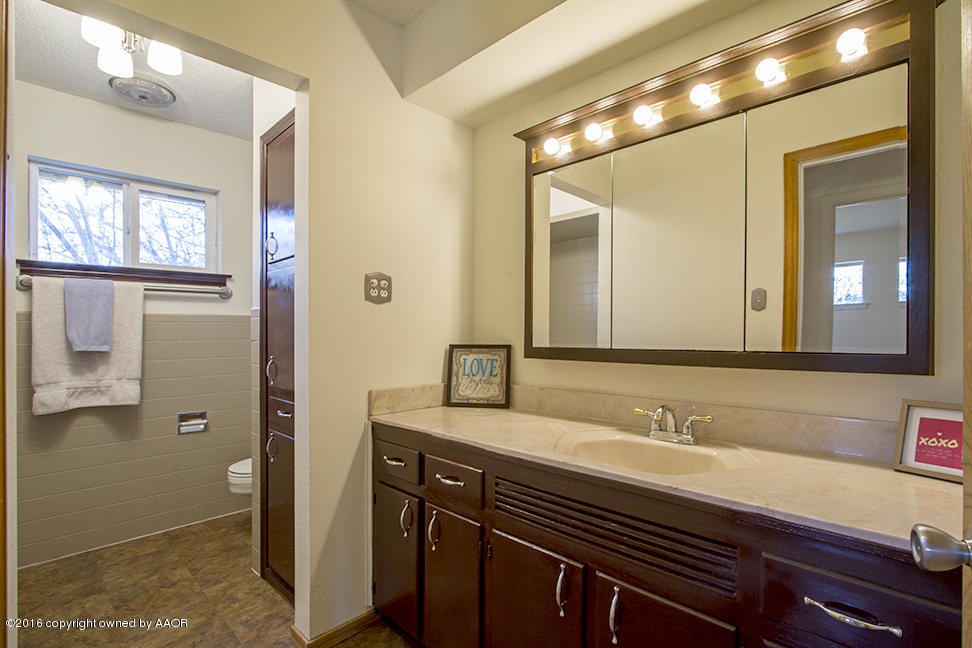 4818 Camp Lane Amarillo, TX 79110 - Photo 18 of 32 a bathroom with a sink and a mirror