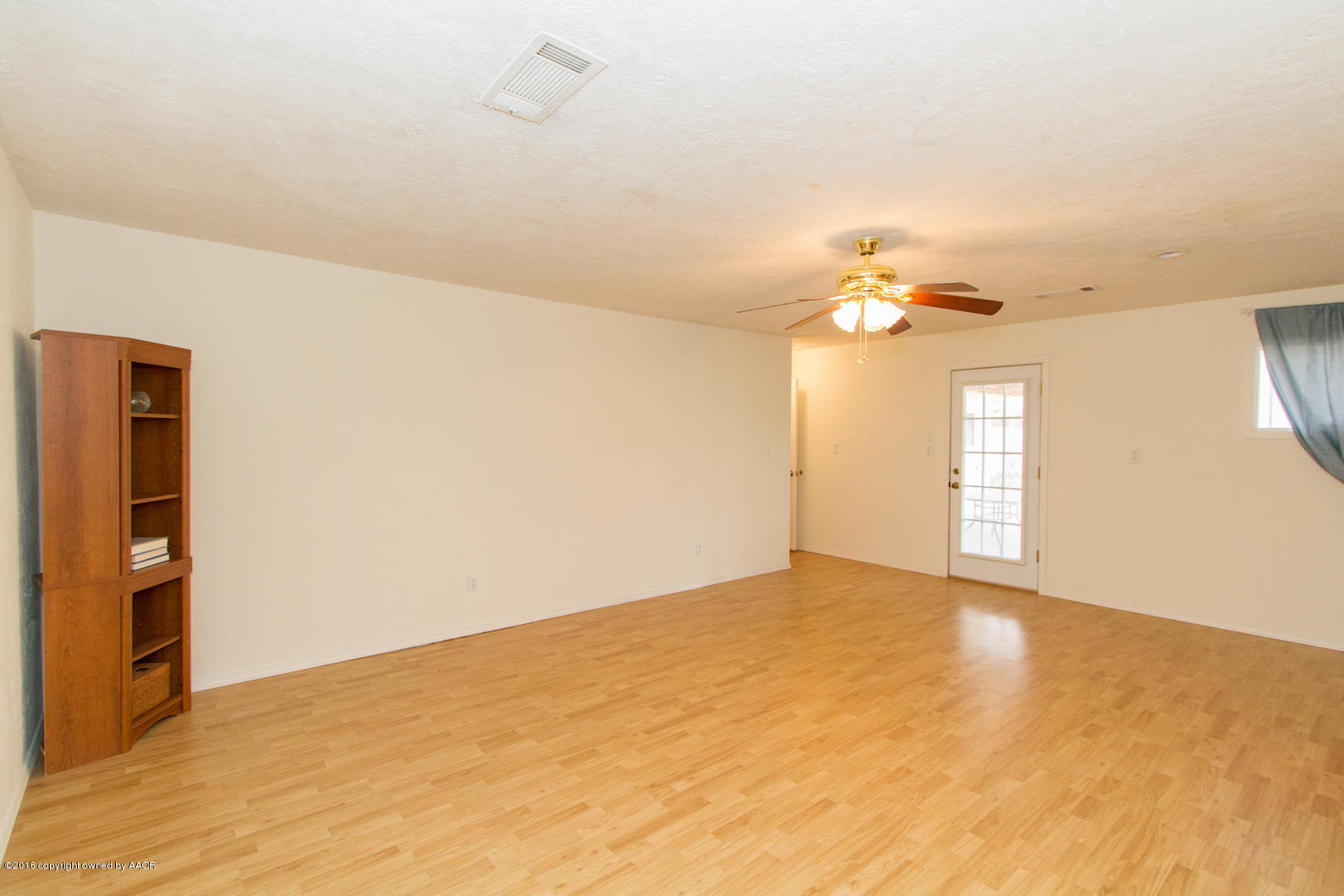4818 Camp Lane Amarillo, TX 79110 - Photo 20 of 32 a view of an empty room with window and wooden floor