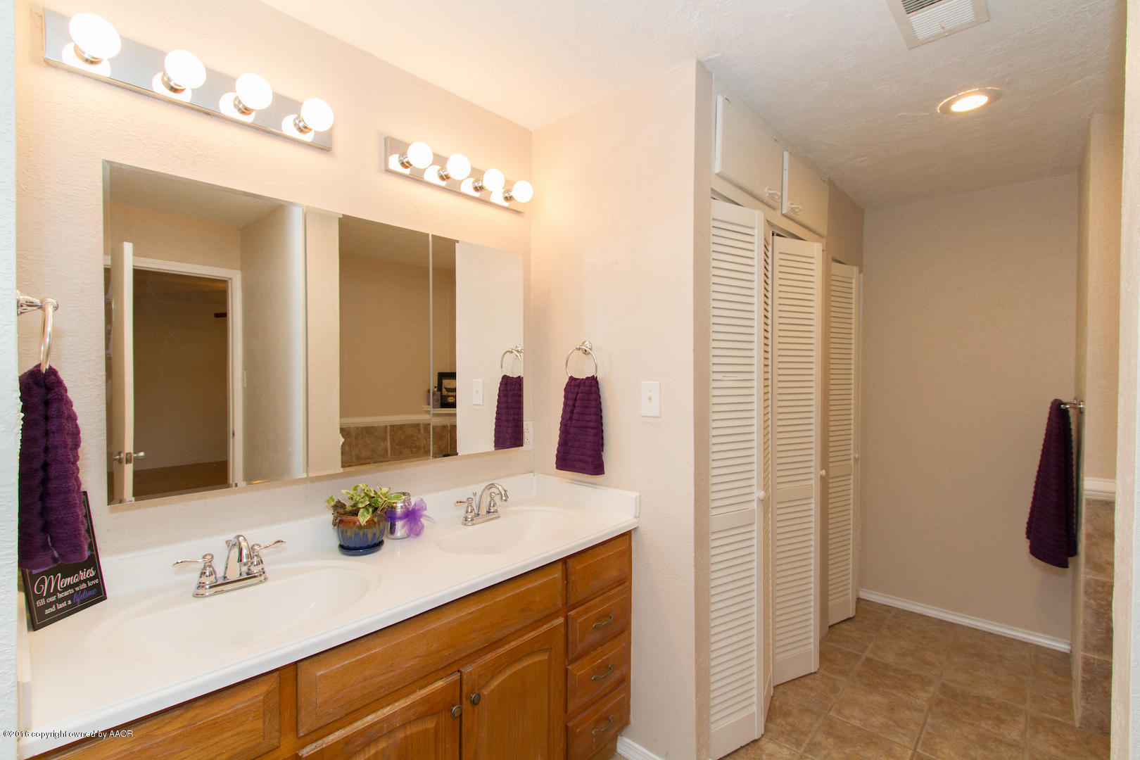 4818 Camp Lane Amarillo, TX 79110 - Photo 22 of 32 a bathroom with a sink vanity and a mirror