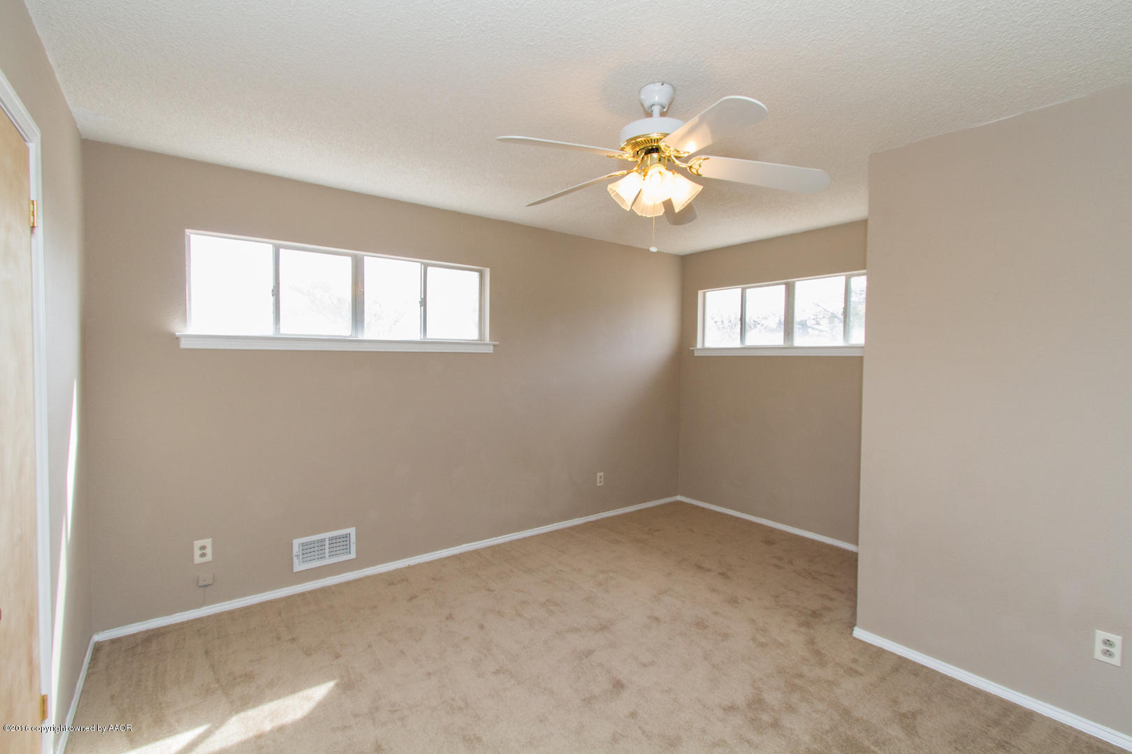 4818 Camp Lane Amarillo, TX 79110 - Photo 26 of 32 an empty room with windows and fan
