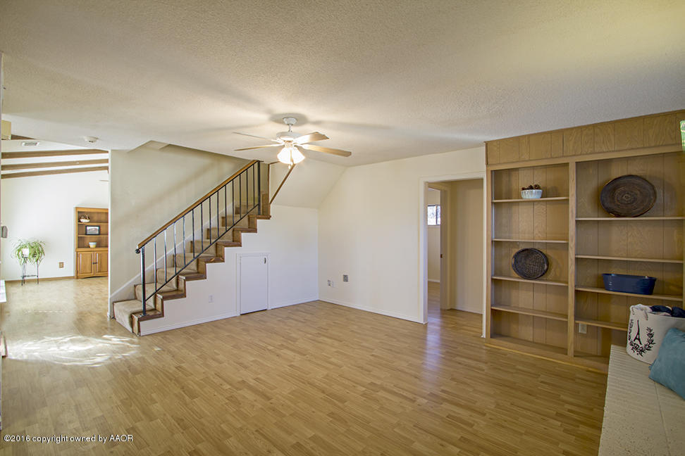 4818 Camp Lane Amarillo, TX 79110 - Photo 8 of 32 a view of an empty room with wooden floor and entryway