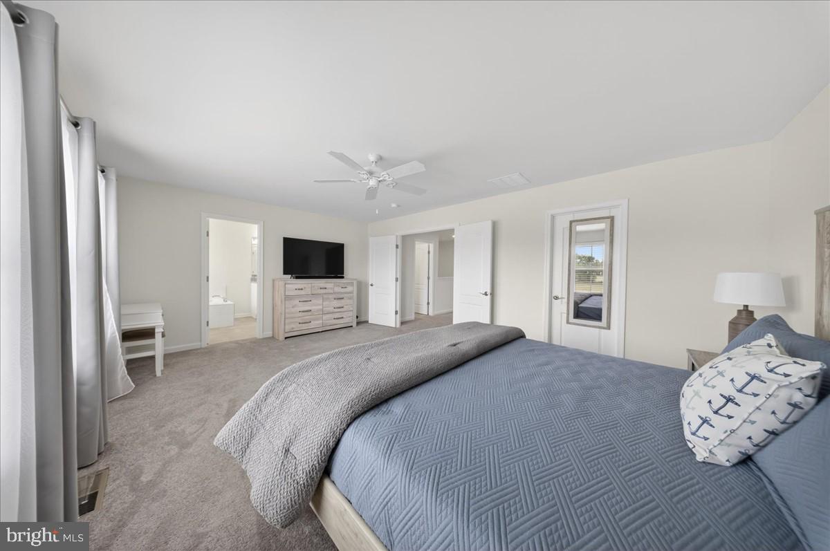 38023 Cross Gate Road Millville, DE 19967 - Photo 14 of 37 a spacious bedroom with a bed and a flat screen tv