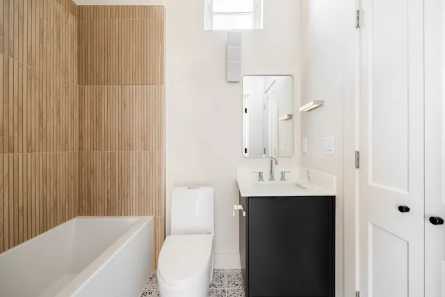 a bathroom with a sink a toilet and shower curtain