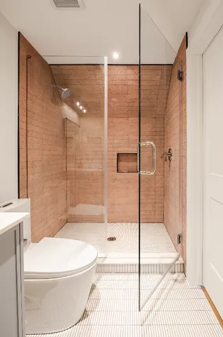 a bathroom with a toilet and a shower