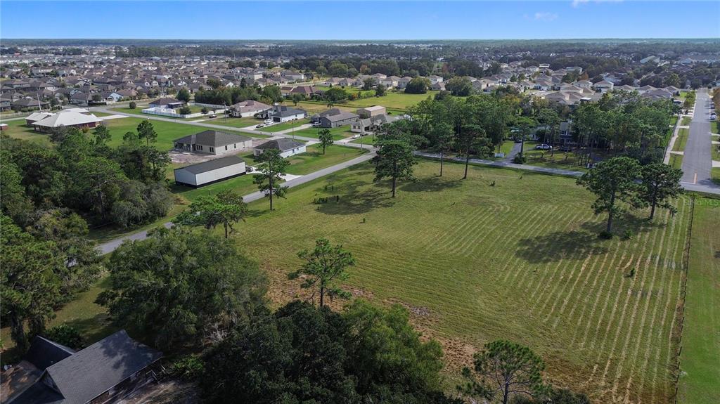 5237 Moore Street St. Cloud, FL 34771 - Photo 16 of 19 an aerial view of residential houses with outdoor space and trees
