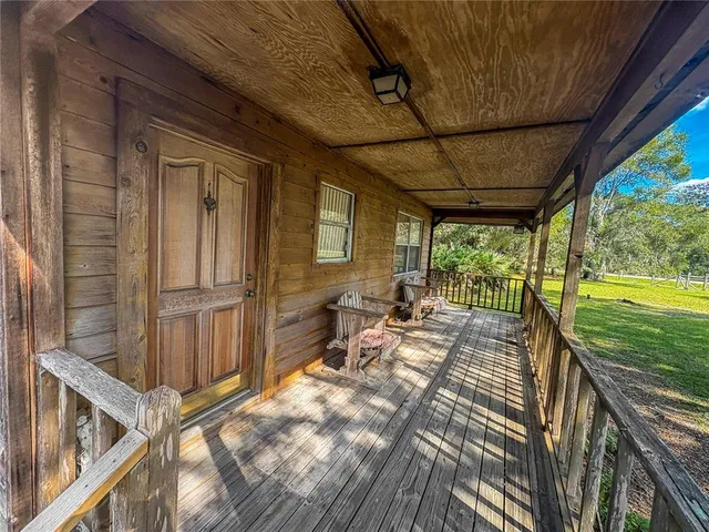 a view of a porch with furniture and garden
