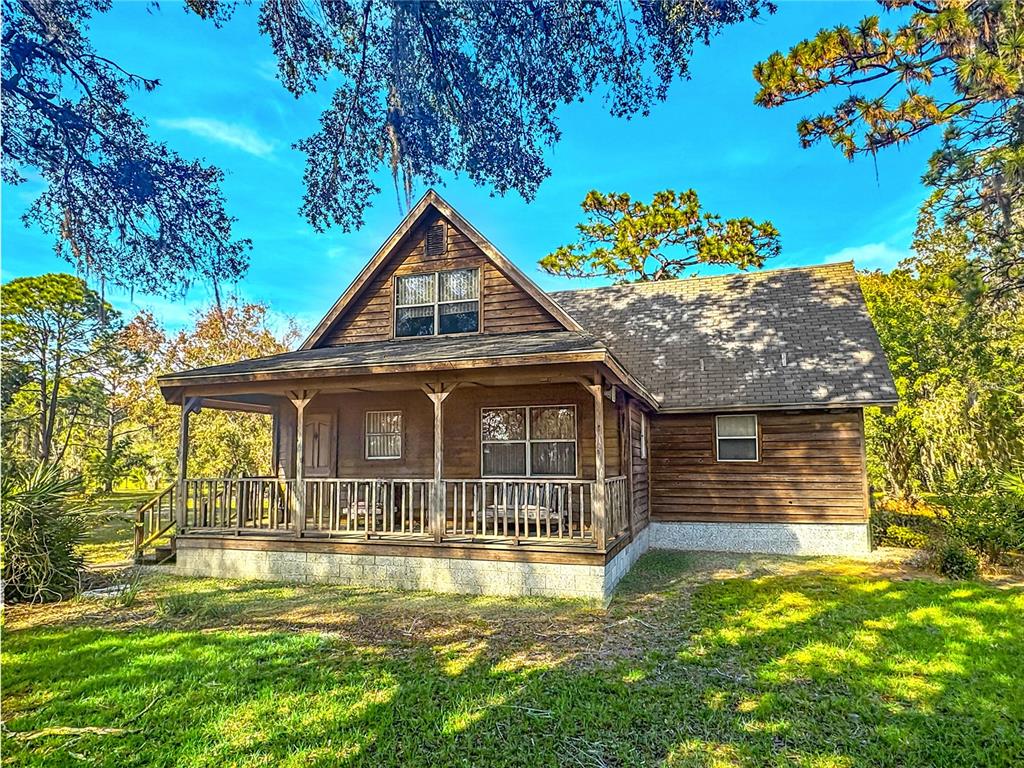 5237 Moore Street St. Cloud, FL 34771 - Photo 3 of 19 a front view of a house with a yard