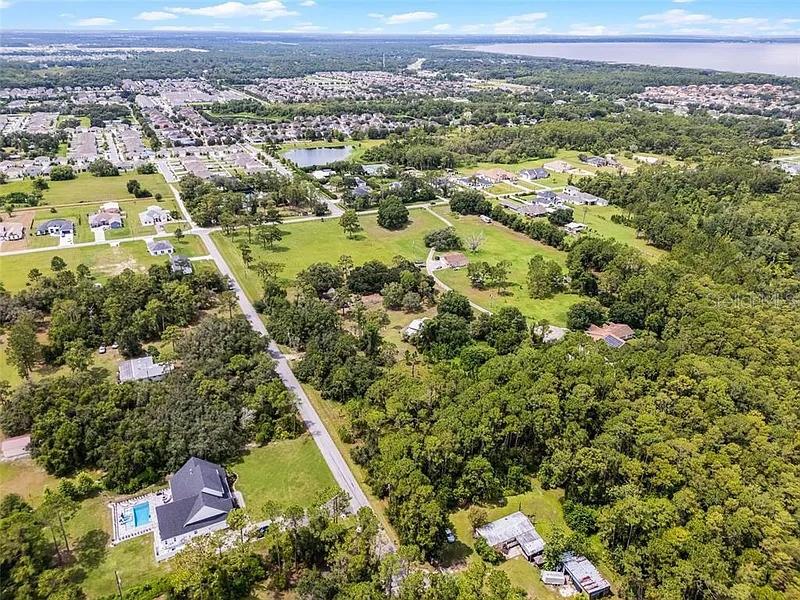 5237 Moore Street St. Cloud, FL 34771 - Photo 7 of 19 an aerial view of residential houses with outdoor space and trees