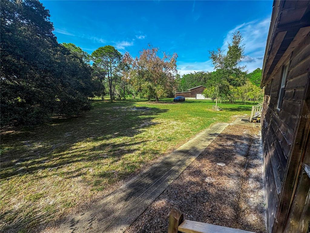 5237 Moore Street St. Cloud, FL 34771 - Photo 10 of 19 a view of a yard with an trees