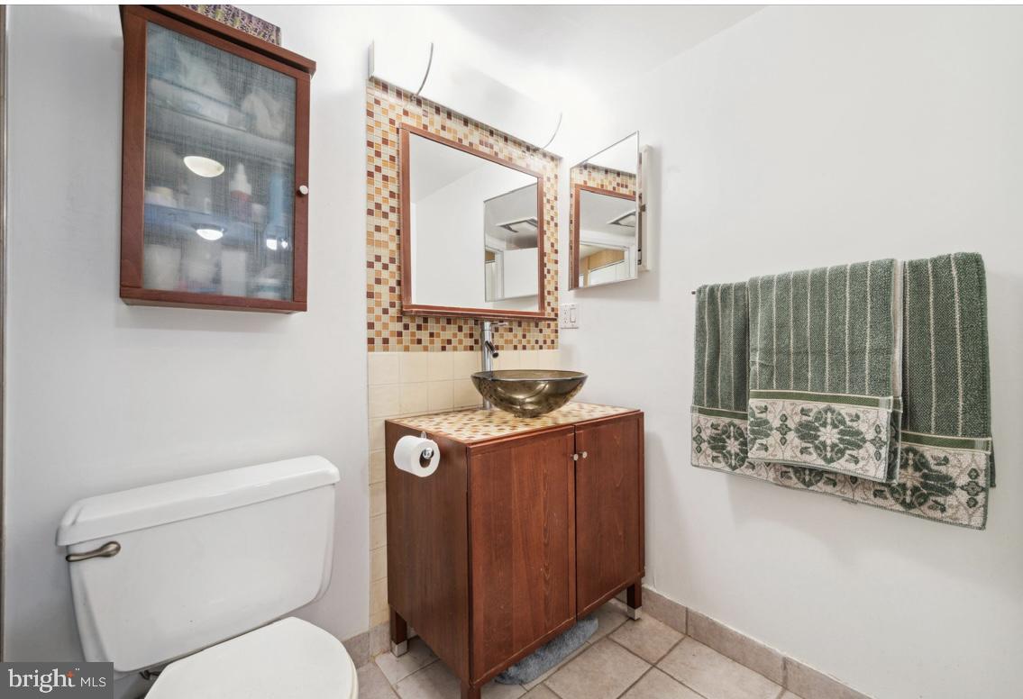 2001 Hamilton Street, Unit 2120 Philadelphia, PA 19130 - Photo 10 of 24 Glass sink , tiled counter and mirror