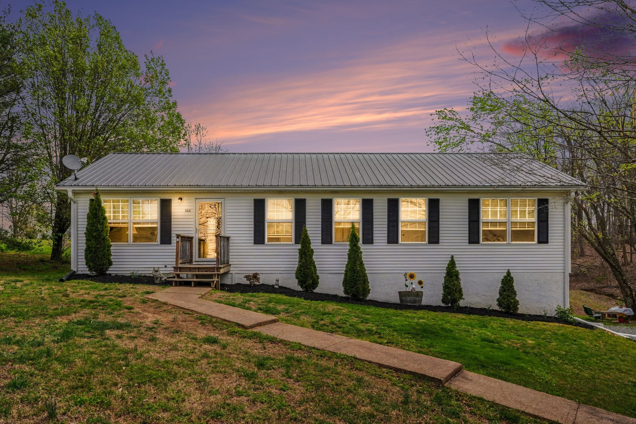 550 Gregory Road Westmoreland, TN 37186 - Photo 1 of 26 a front view of a house with a garden