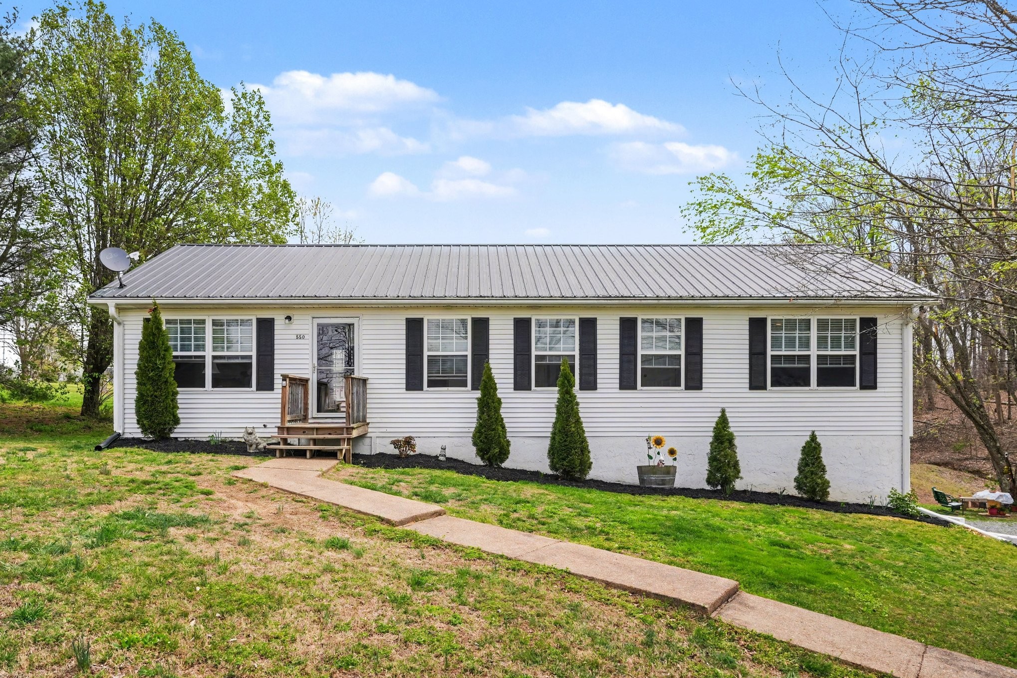 550 Gregory Road Westmoreland, TN 37186 - Photo 23 of 26 a view of a house with a yard and sitting area