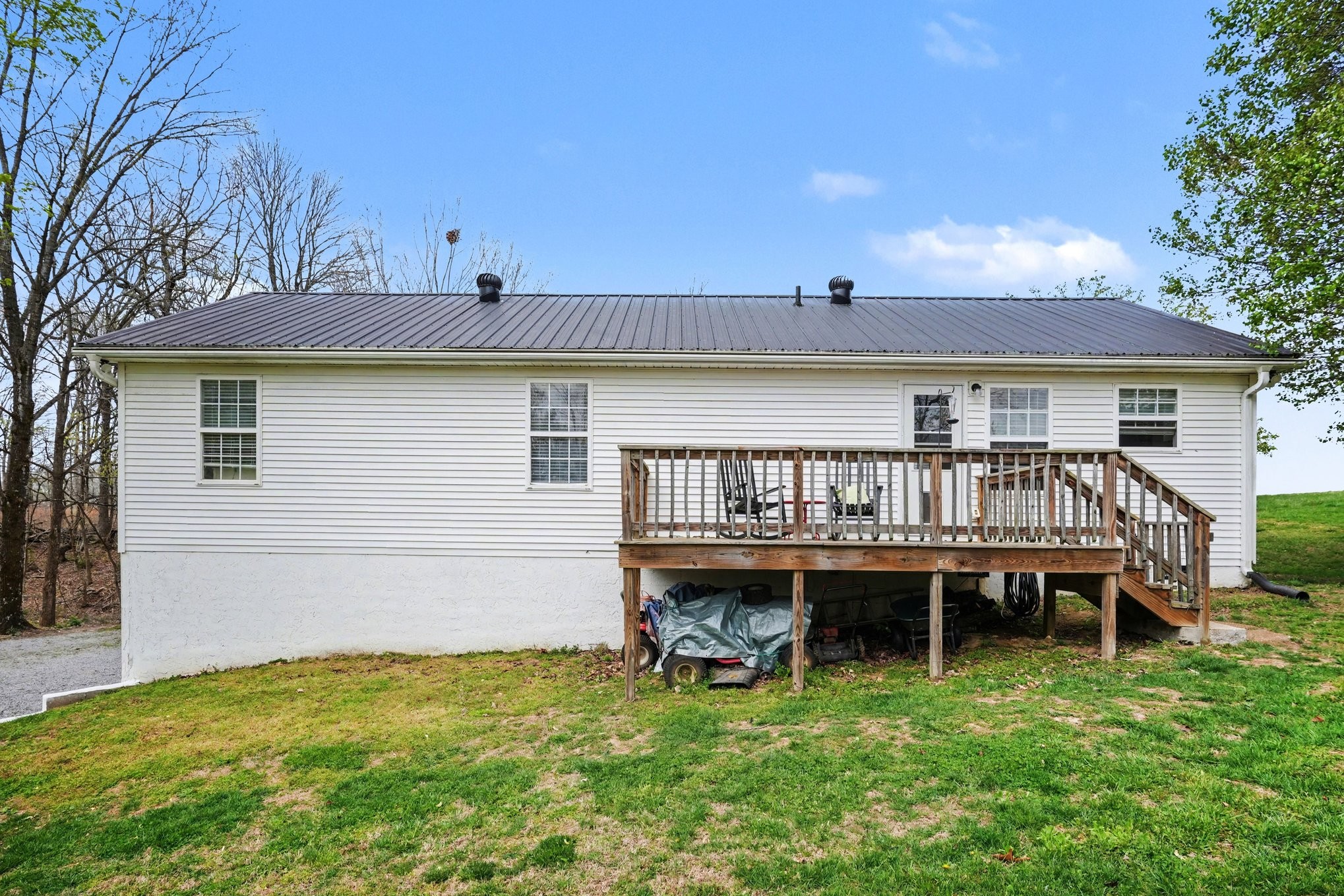 550 Gregory Road Westmoreland, TN 37186 - Photo 25 of 26 a view of a house with a deck and a wooden deck