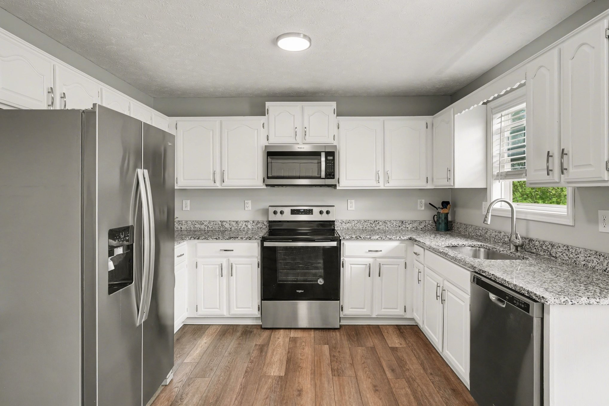 550 Gregory Road Westmoreland, TN 37186 - Photo 5 of 26 a kitchen with a refrigerator stove and sink