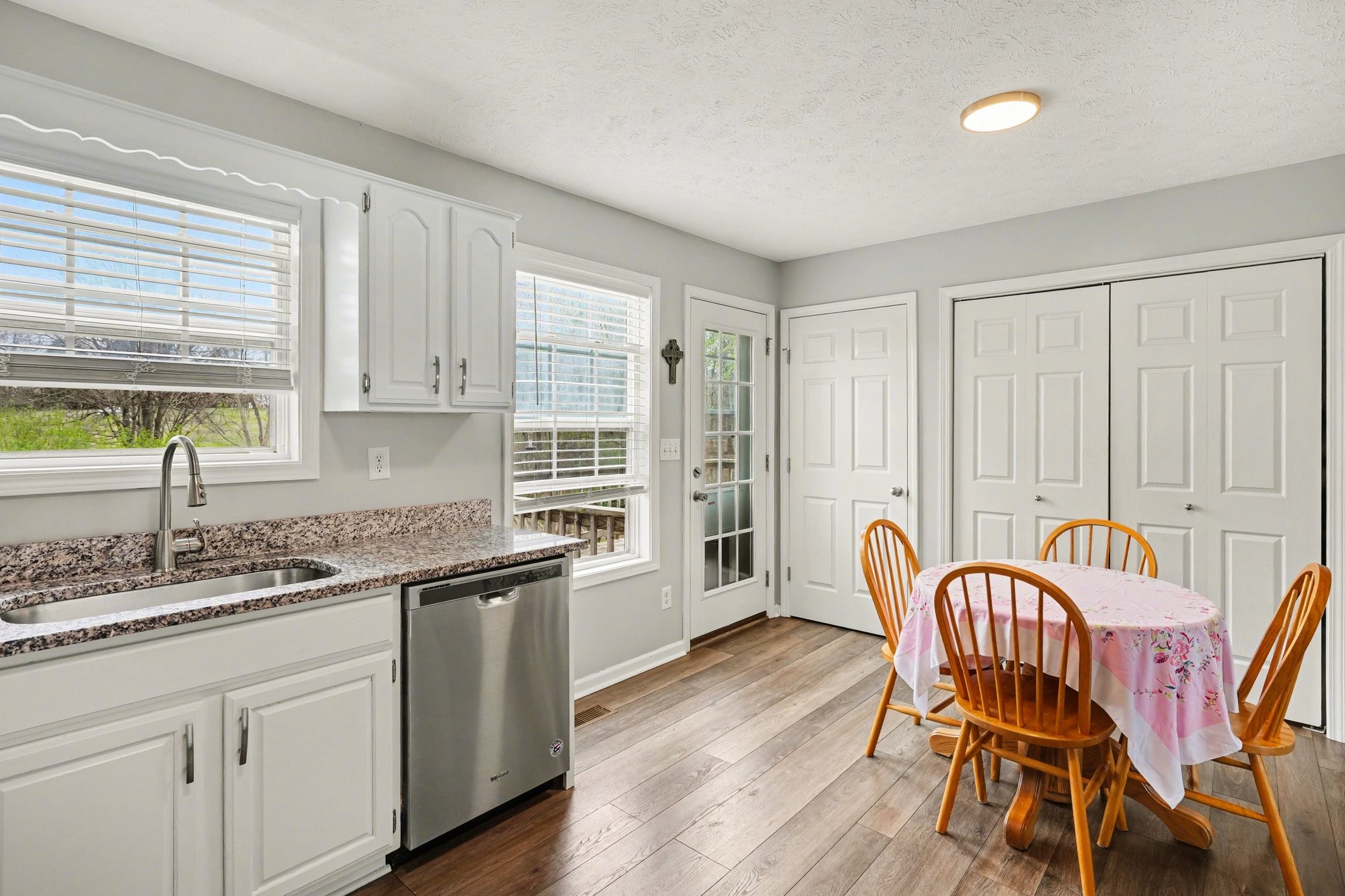 550 Gregory Road Westmoreland, TN 37186 - Photo 7 of 26 a kitchen with stainless steel appliances granite countertop a table chairs sink and cabinets