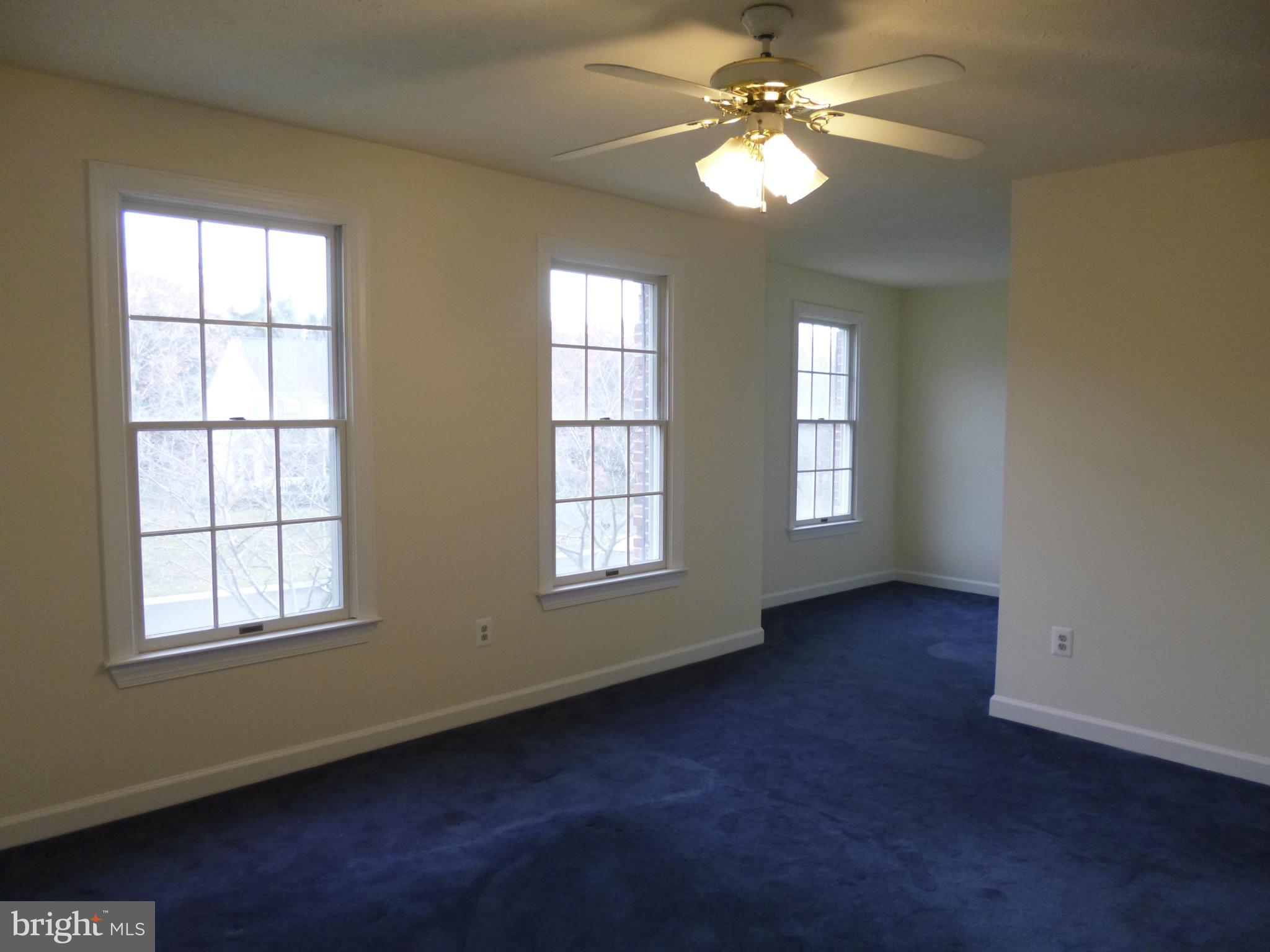 8837 Herons Flight Laurel, MD 20723 - Photo 18 of 29 an empty room with windows and ceiling fan