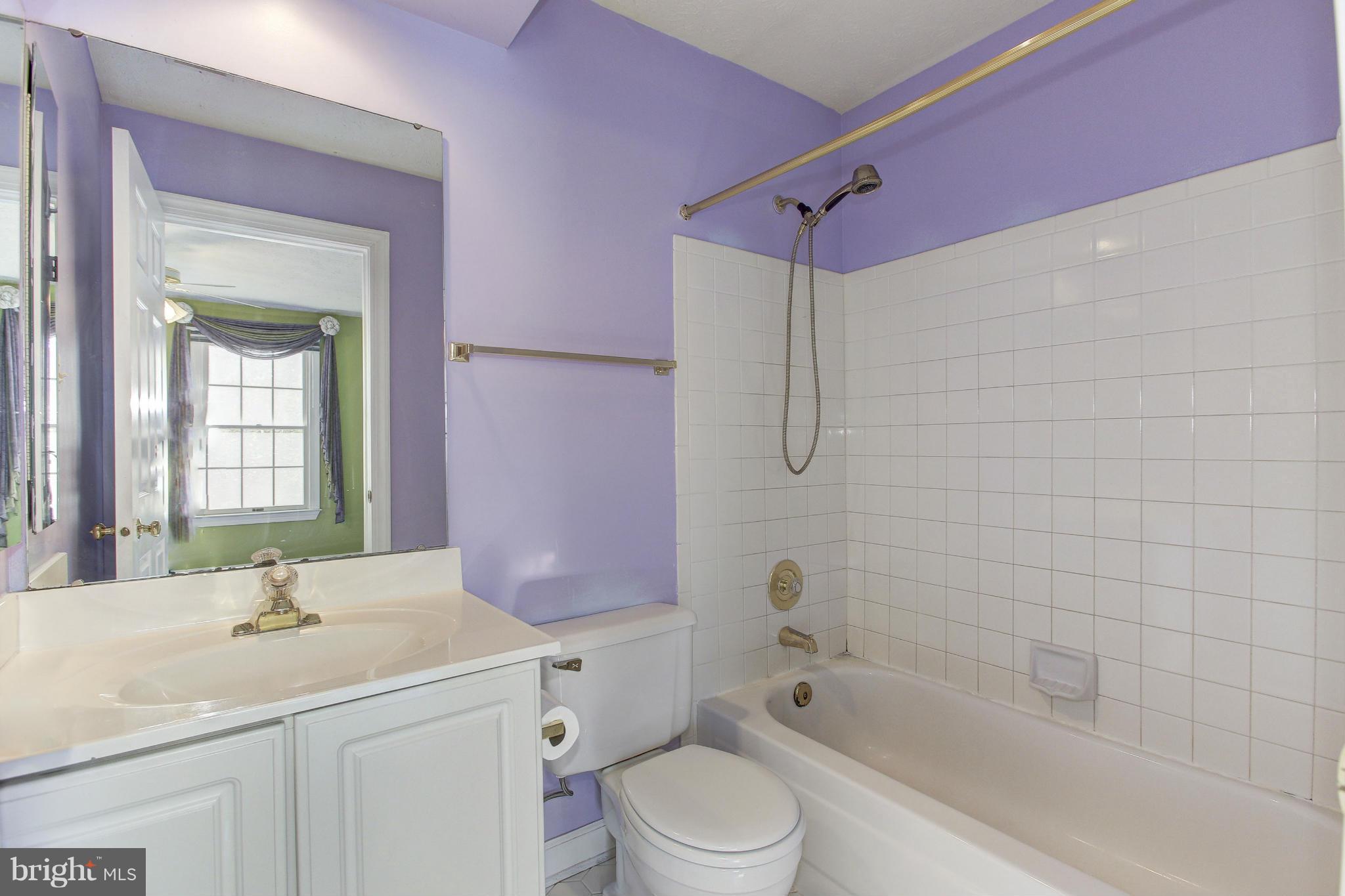 8837 Herons Flight Laurel, MD 20723 - Photo 19 of 29 a bathroom with a granite countertop sink a toilet and shower