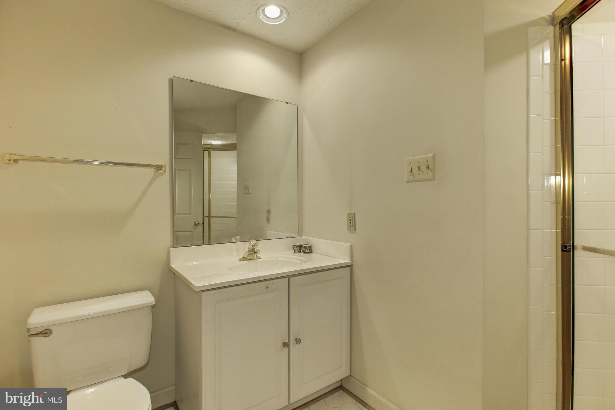 8837 Herons Flight Laurel, MD 20723 - Photo 24 of 29 a bathroom with a toilet sink and mirror