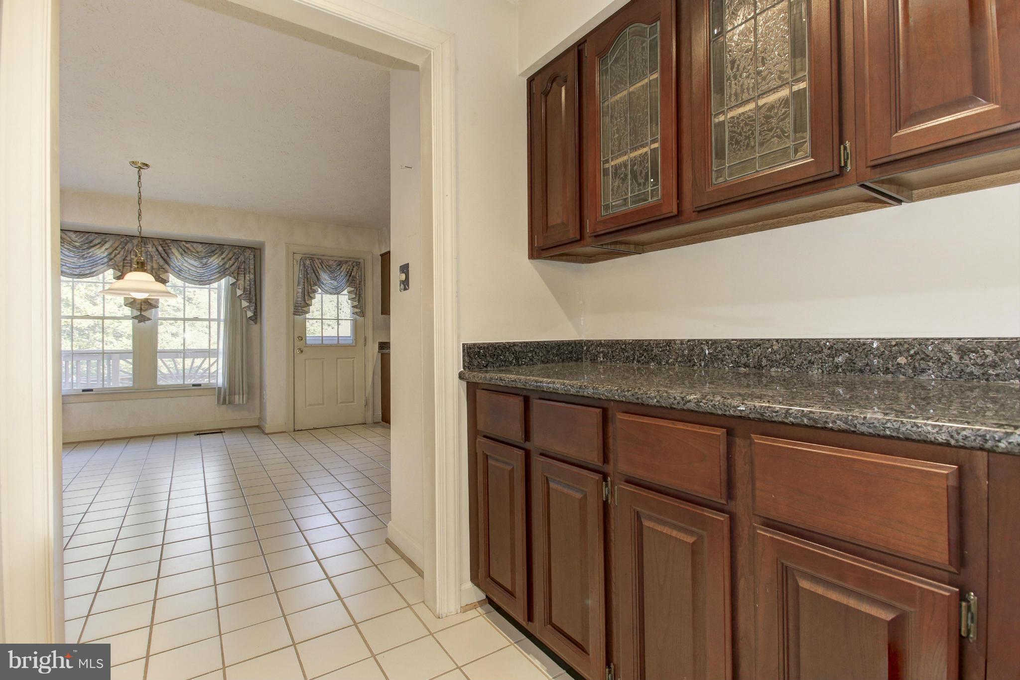 8837 Herons Flight Laurel, MD 20723 - Photo 6 of 29 a kitchen with stainless steel appliances granite countertop a refrigerator and cabinets