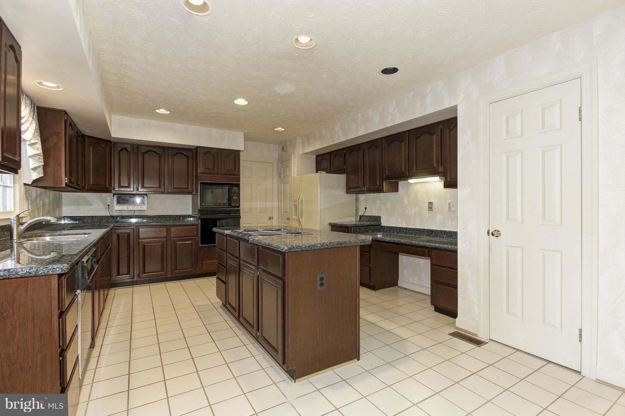 8837 Herons Flight Laurel, MD 20723 - Photo 8 of 29 a kitchen with stainless steel appliances granite countertop a sink counter space cabinets and a large window