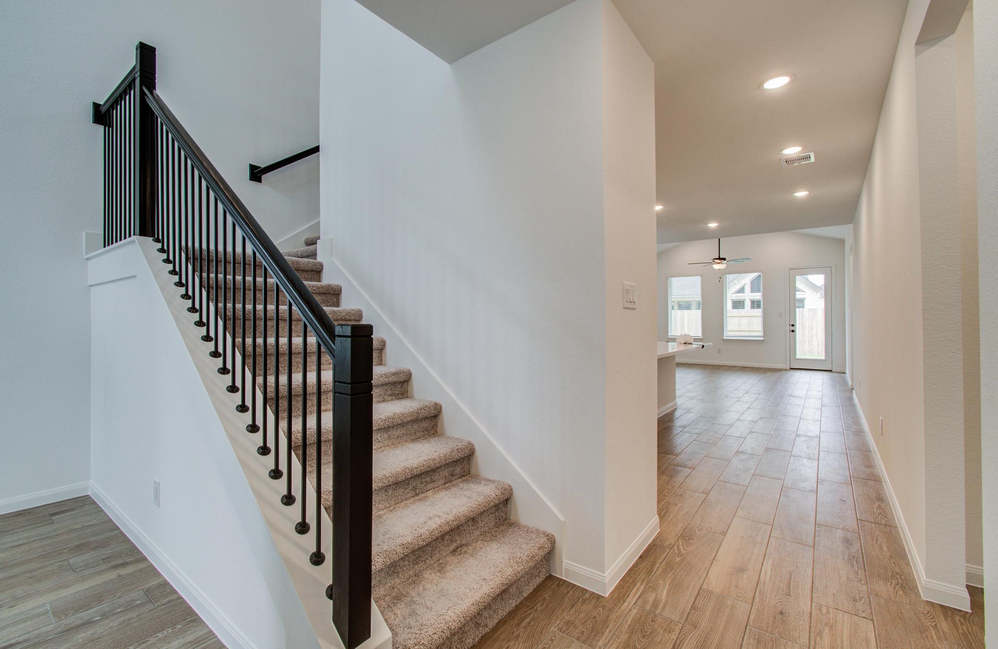 7231 Yarrow Blossom Court Katy, TX 77493 - Photo 14 of 49 a view of a hallway with wooden floor and staircase