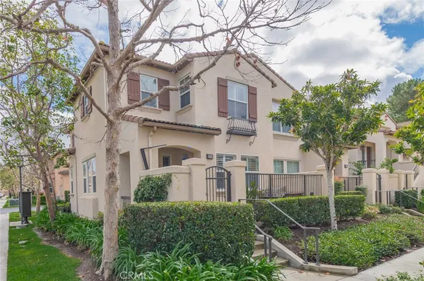 a front view of a house with porch and green space