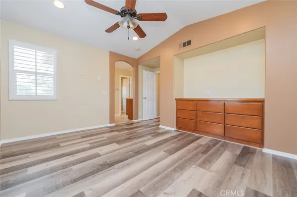 a view of a livingroom with wooden floor and cabinet