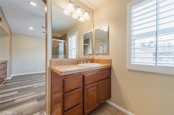 a bathroom with a sink vanity and a mirror