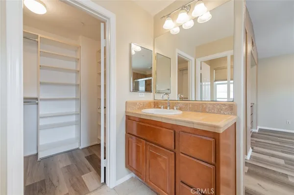 a bathroom with a sink vanity and a mirror