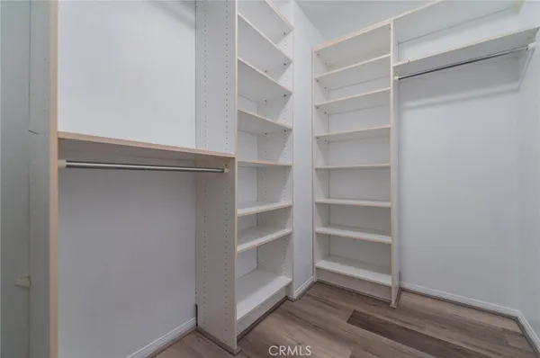a view of walk in closet with empty racks