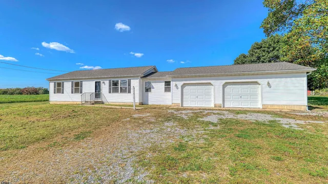 a view of a house with a backyard