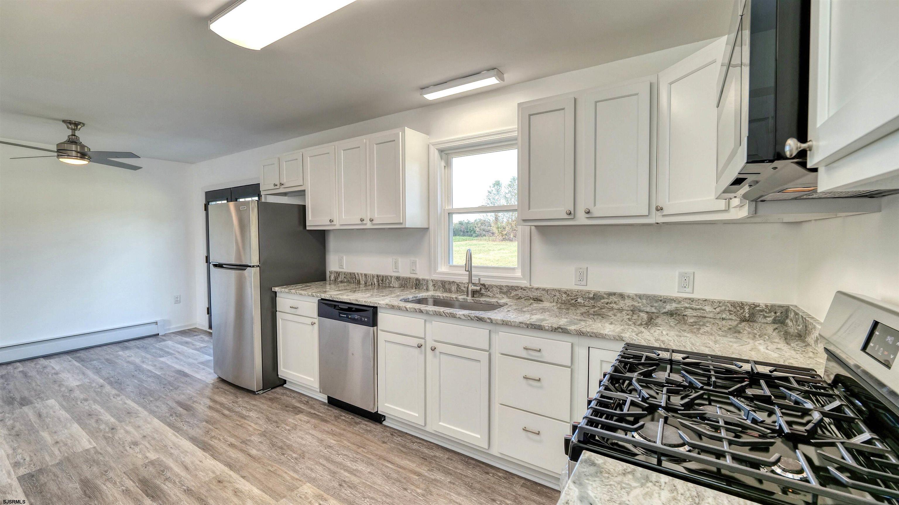 1510 East Wheat Road Vineland, NJ 08360 - Photo 11 of 26 a kitchen with stainless steel appliances granite countertop a stove and a refrigerator