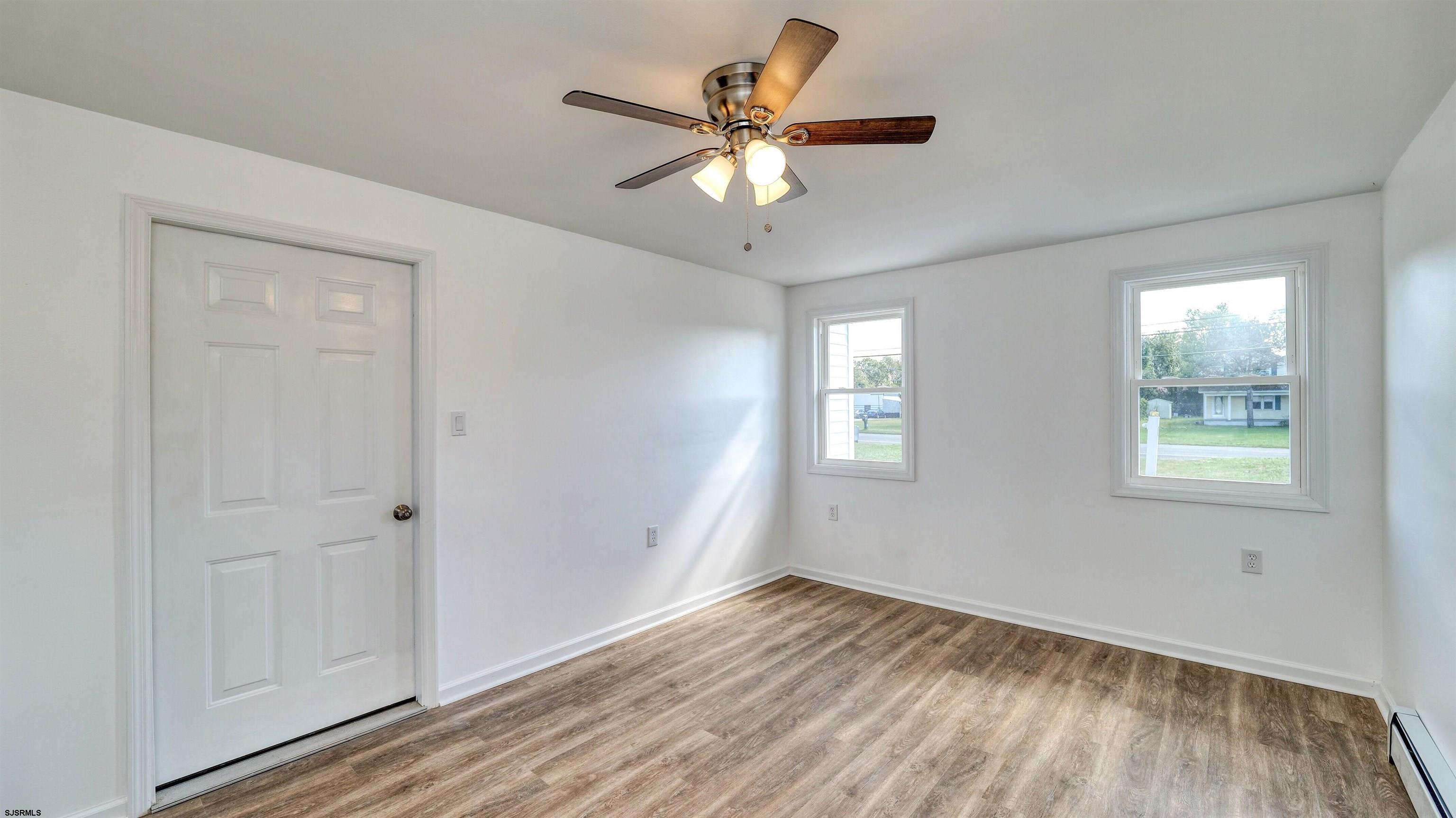 1510 East Wheat Road Vineland, NJ 08360 - Photo 12 of 26 a view of an empty room with wooden floor and a window