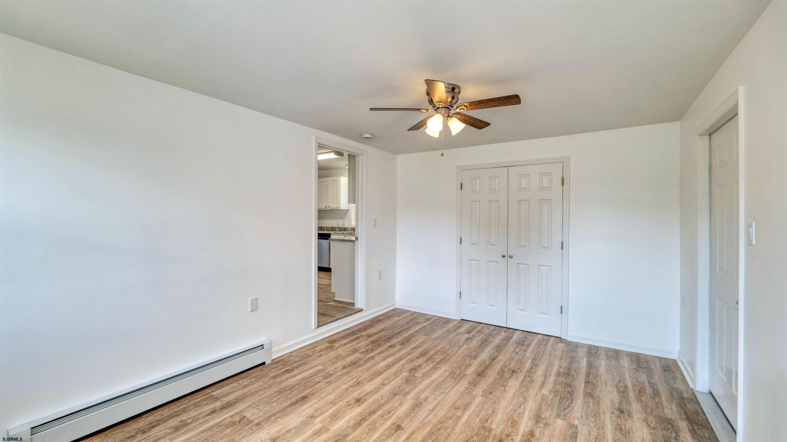 1510 East Wheat Road Vineland, NJ 08360 - Photo 13 of 26 a view of empty room with wooden floor and fan