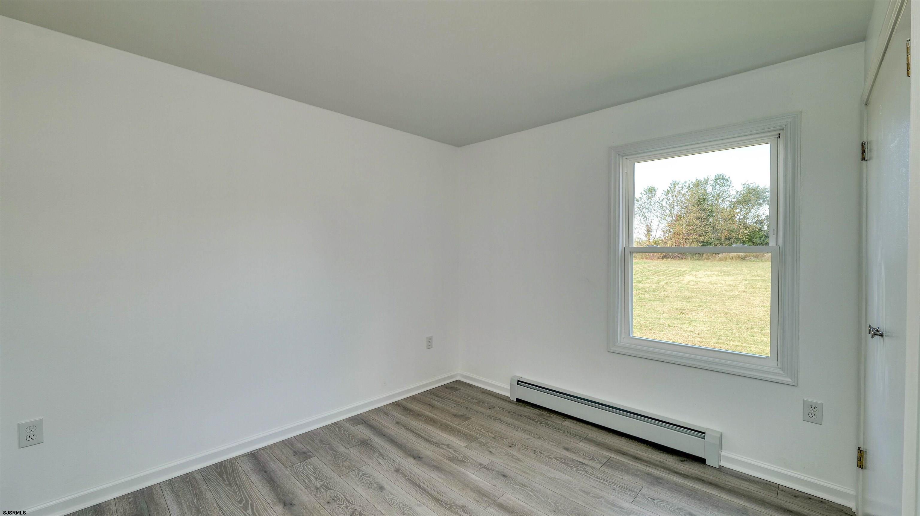1510 East Wheat Road Vineland, NJ 08360 - Photo 18 of 26 wooden floor in an empty room with a window