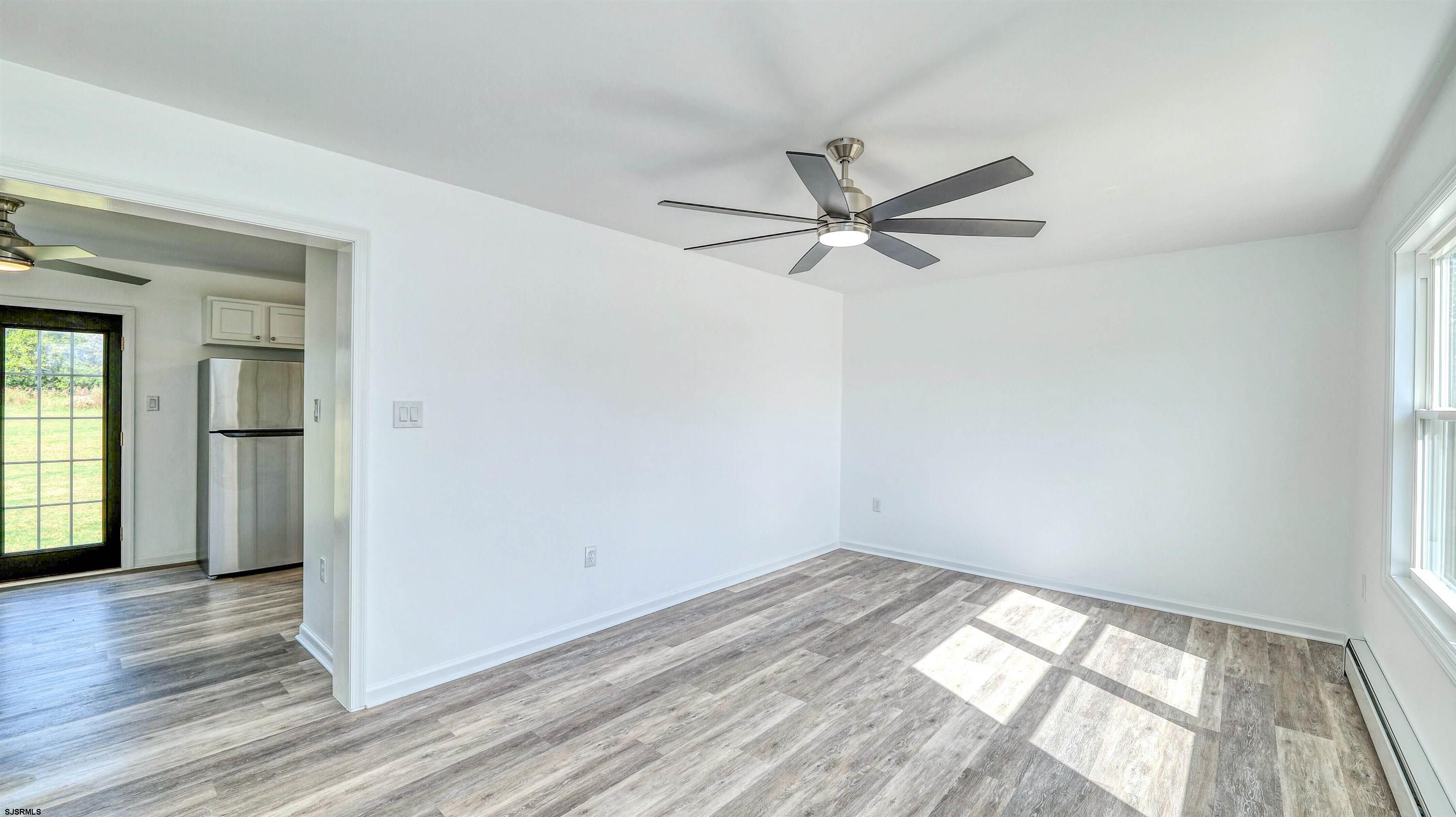 1510 East Wheat Road Vineland, NJ 08360 - Photo 4 of 26 a view of empty room with wooden floor and fan