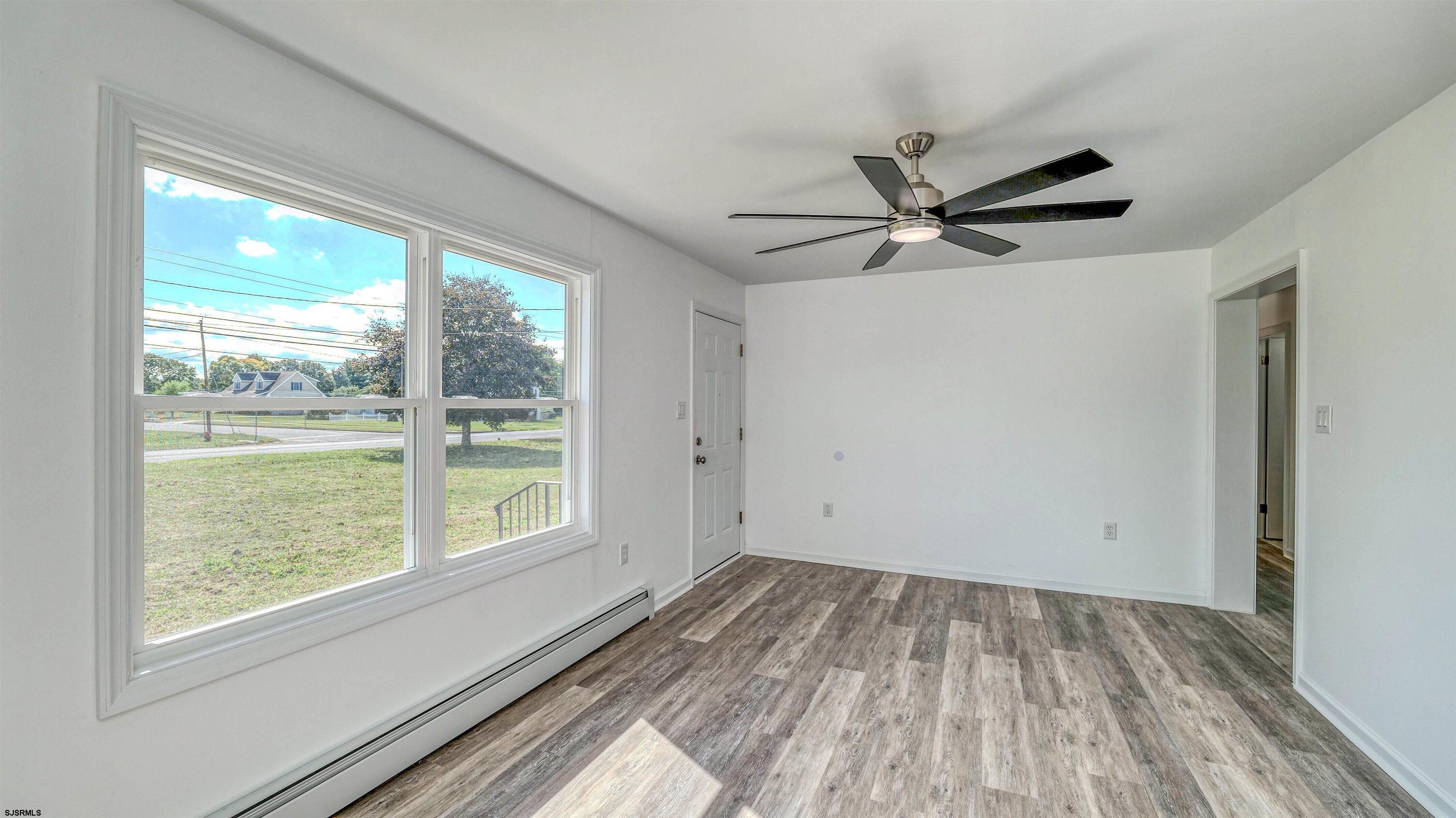1510 East Wheat Road Vineland, NJ 08360 - Photo 6 of 26 a view of empty room with wooden floor and fan