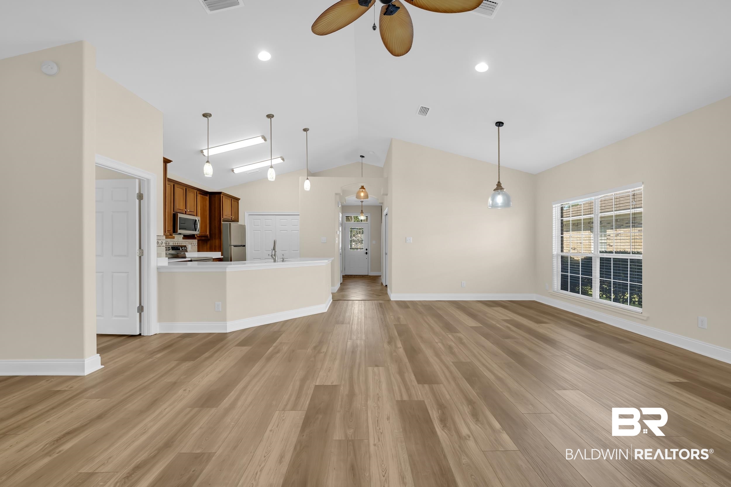 226 Hemingway Loop Foley, AL 36535 - Photo 12 of 53 Unfurnished living room with light wood-style flooring, a ceiling fan, lofted ceiling, and recessed lighting