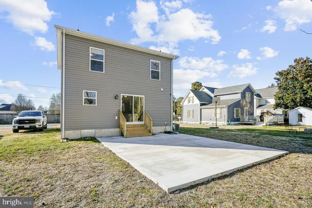 a view of a house with a yard and pathway