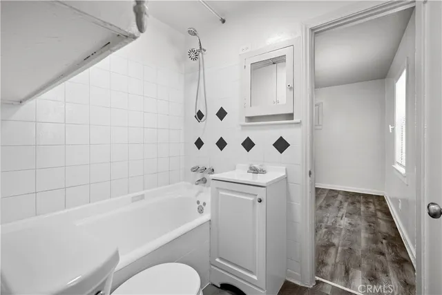 a view of a closet area with wooden floor