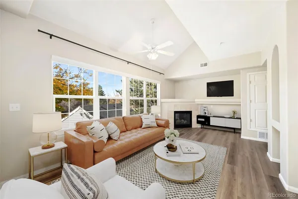 a living room with furniture a fireplace and a flat screen tv