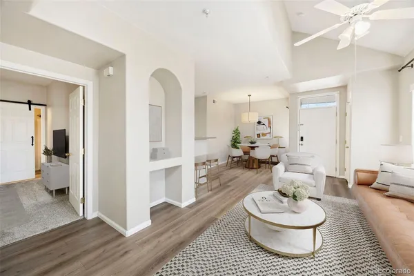 a living room with furniture and wooden floor