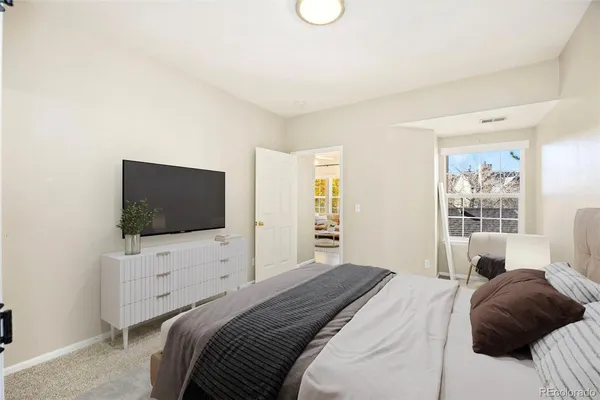 a bedroom with a bed and a flat screen tv